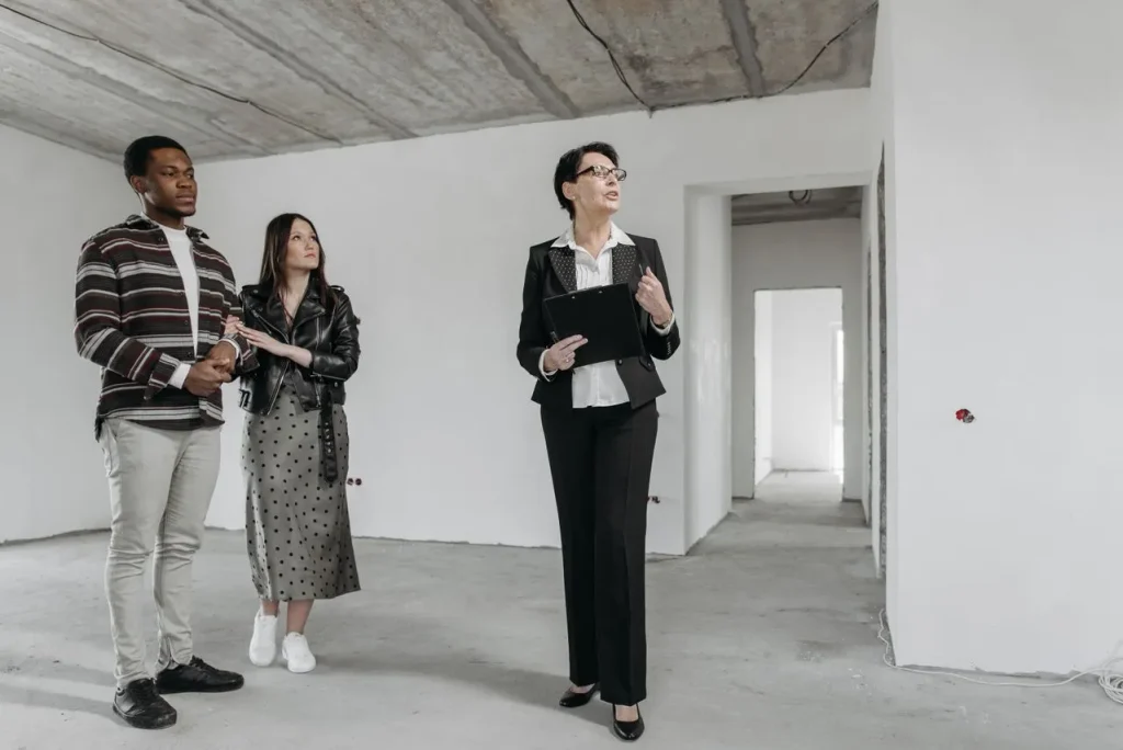 real estate agent with clients inside a home