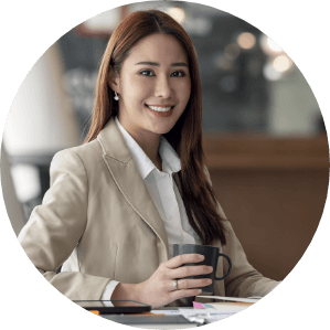 elegant businesswoman holding mug working laptop