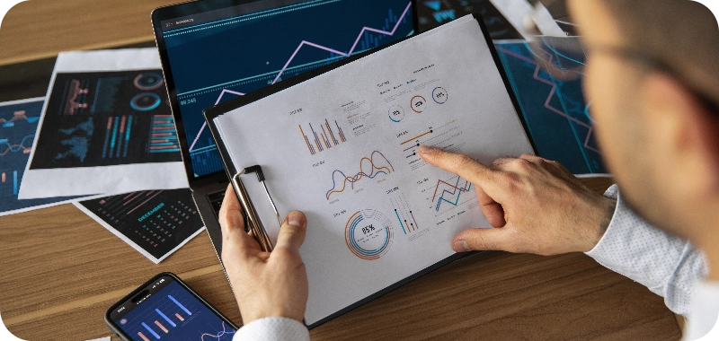 office workers using finance graphs